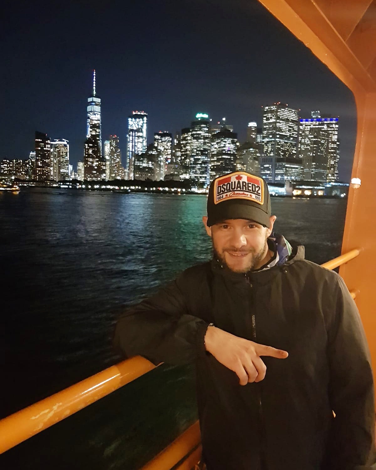 Harry Shotta standing on boat with New York behind him.